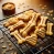 DALL·E 2024-11-05 20.12.55 - A detailed image of freshly baked dog treats on a cooling rack. The treats are bone-shaped and heart-shaped, golden-brown with a slightly crunchy text